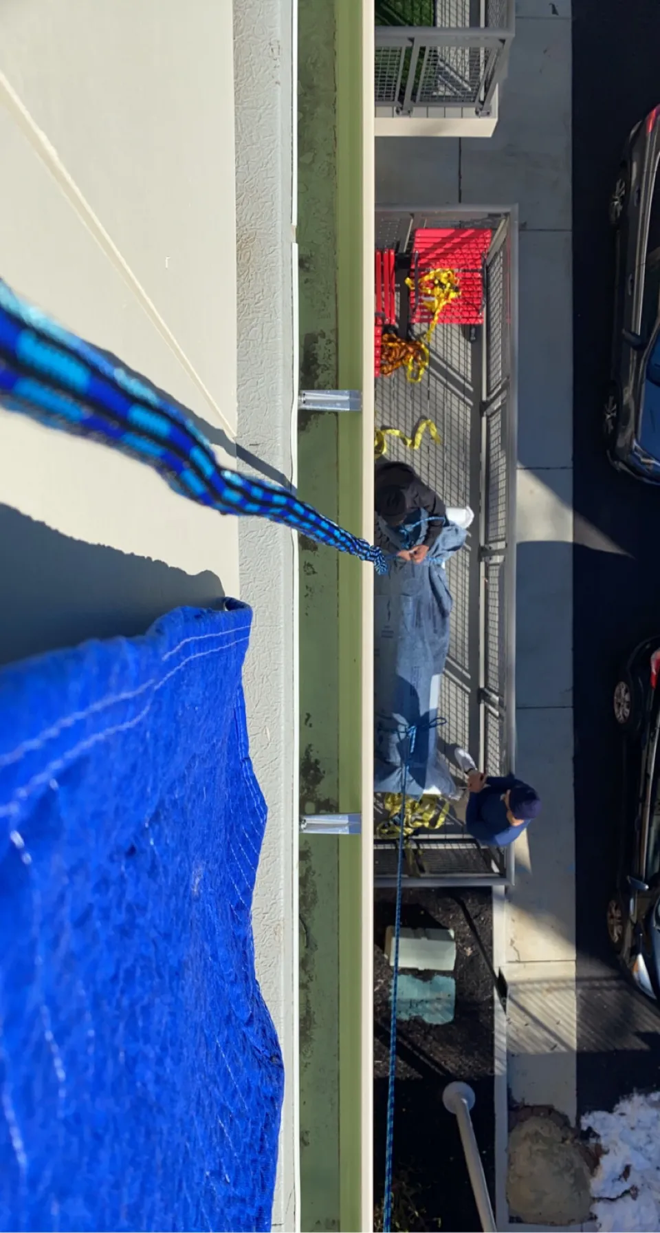 Hoisting over a fourth-floor balcony