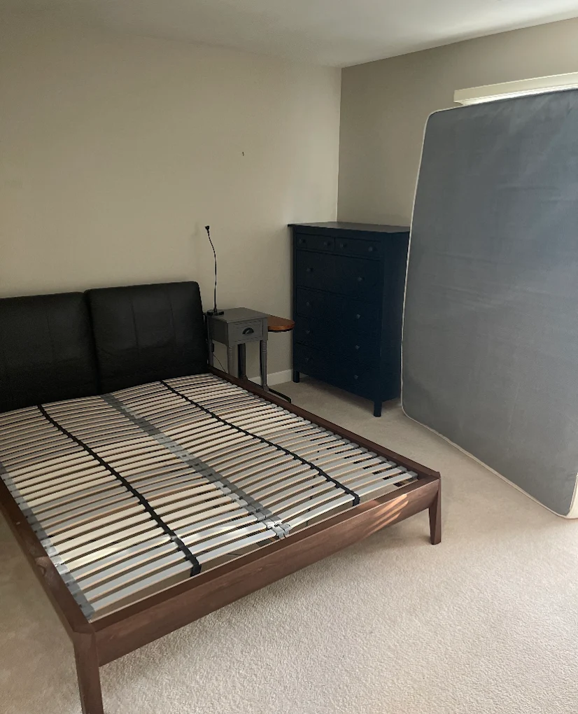 Platform bed broken down, mattress staged