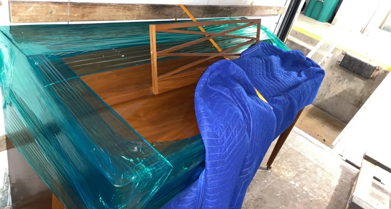 Piano shrink-wrapped before it ever moved
