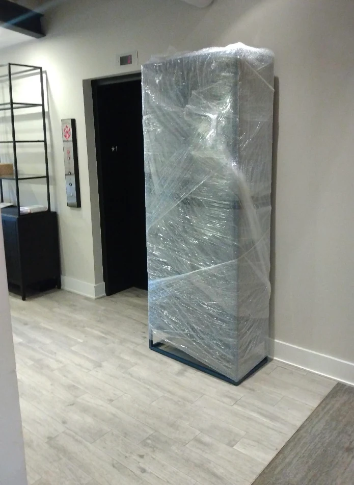 Shrink-wrapped bookcase at the elevator